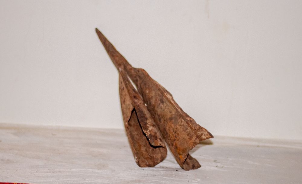 Two corroded iron blades leaning together