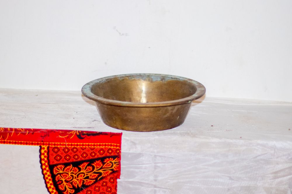 A brass basin with a rolled rim