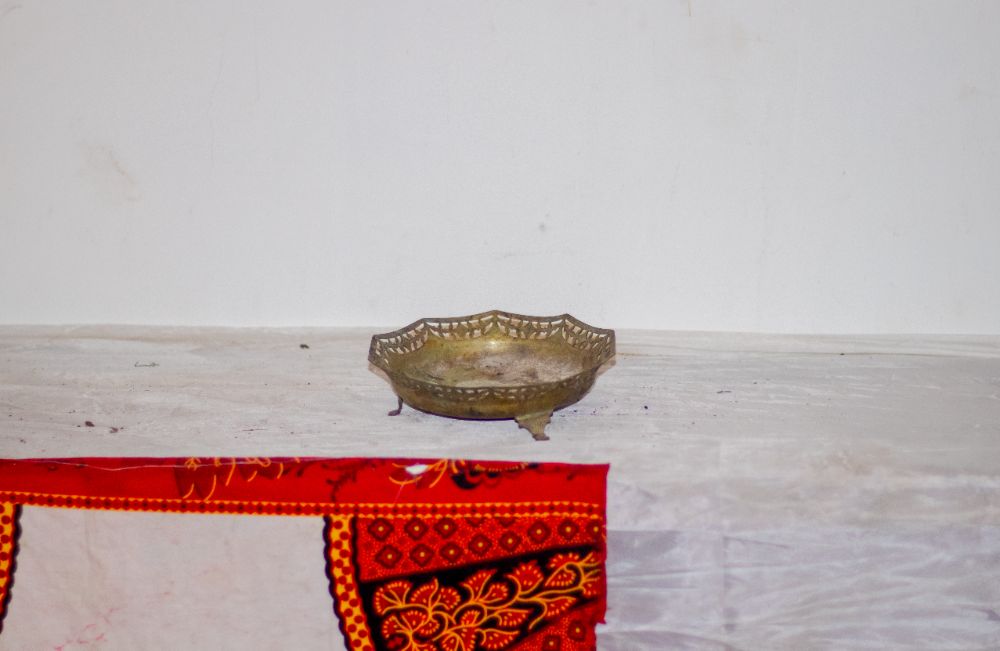A small footed brass dish with a pierced border