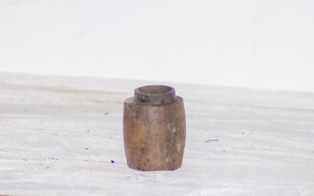 A small brass jar with a narrow neck