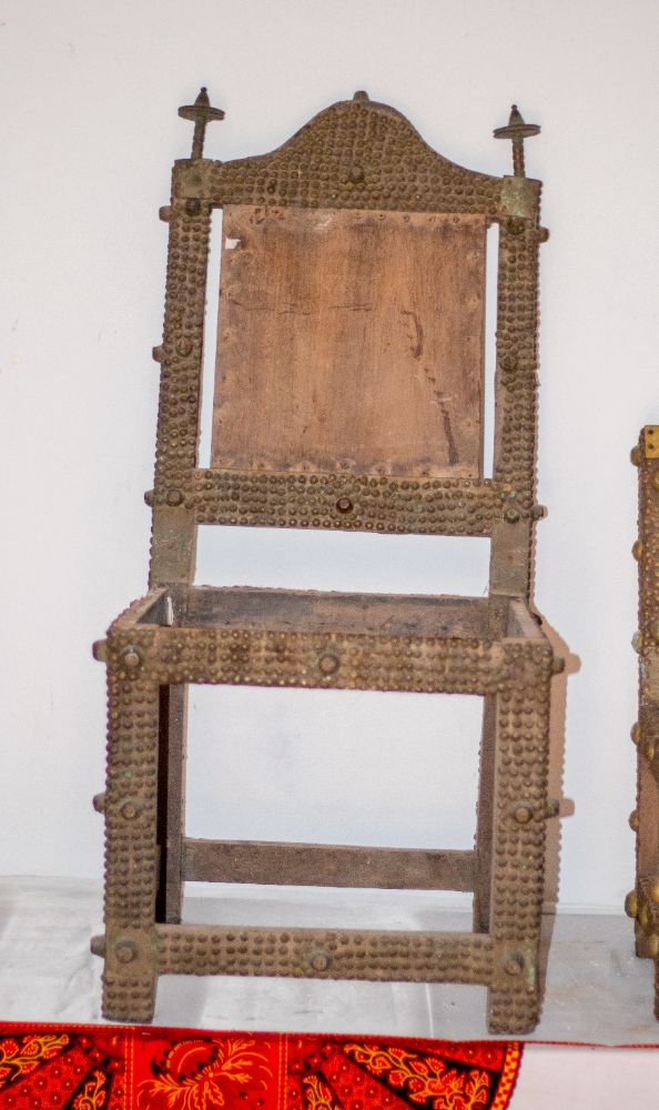 The studded back and frame of an asipim chair