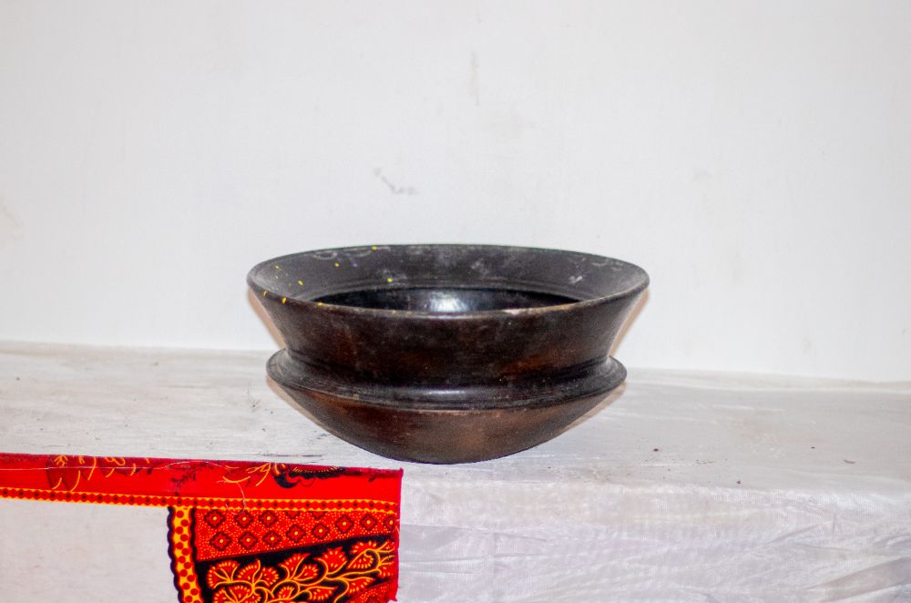 A black clay bowl with a flared rim