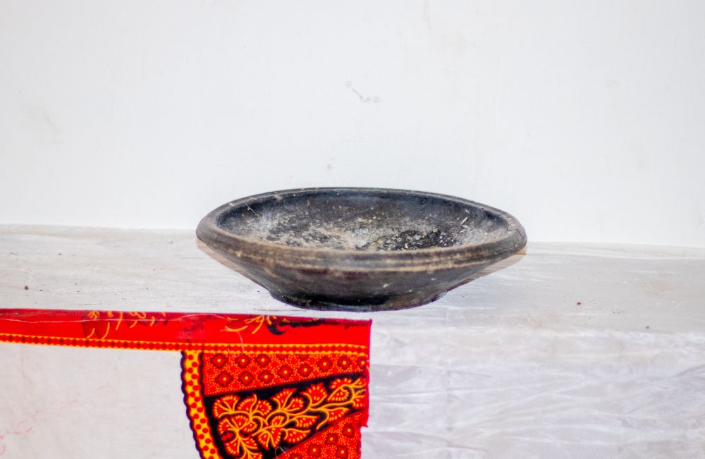 A shallow black clay dish