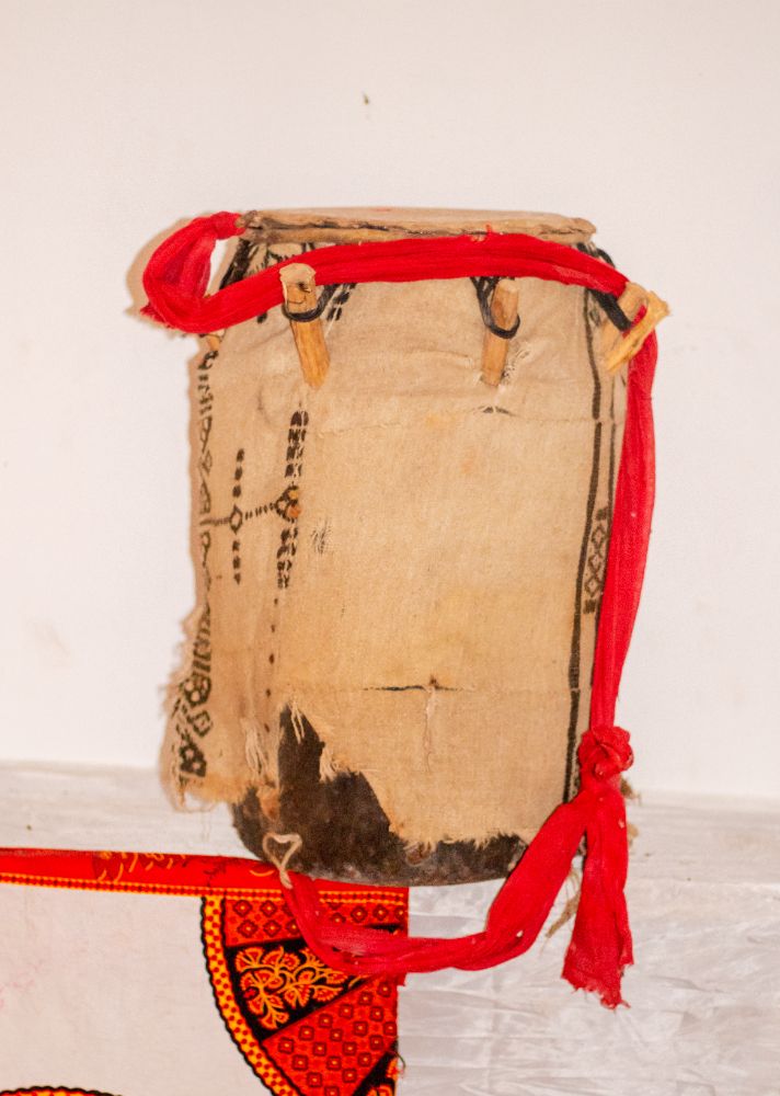 A cloth-covered drum tied with red bands