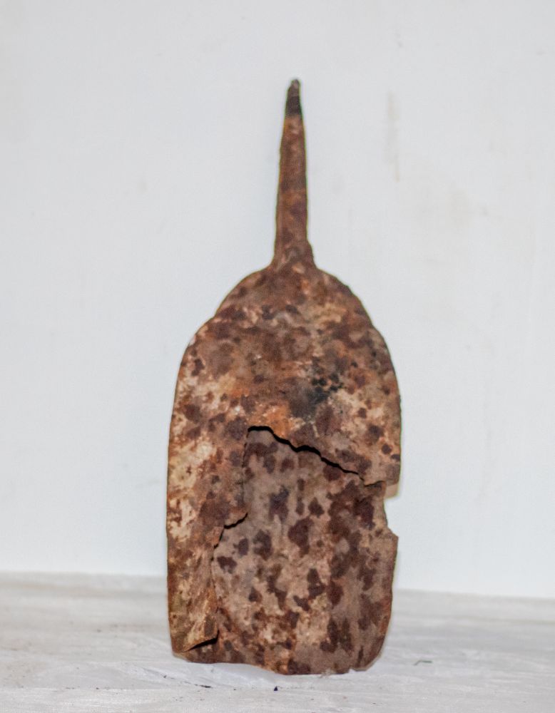 A corroded iron hoe blade with tang
