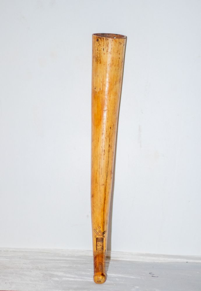 A carved ivory horn standing upright