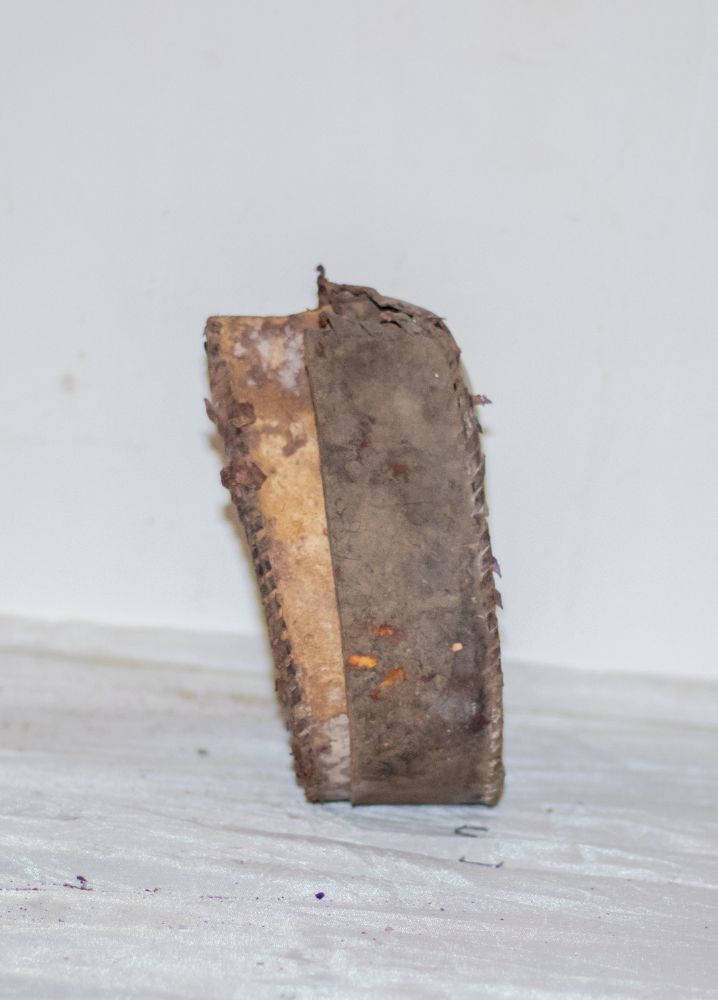 A stitched leather cylindrical case