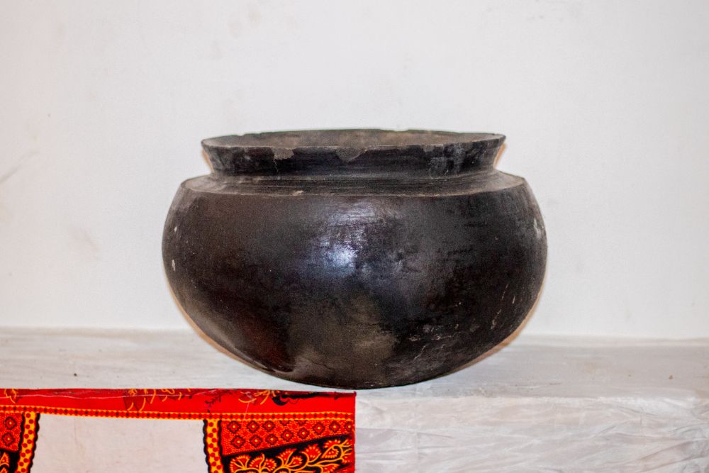 A large blackened clay cooking pot