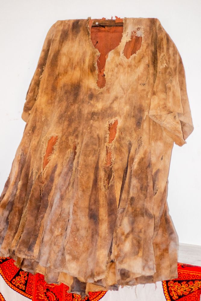 A worn and torn smock stained by dye
