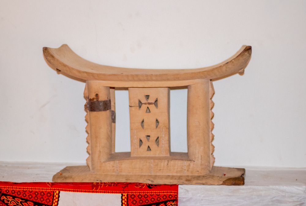 A pale carved Akan stool with openwork centre column