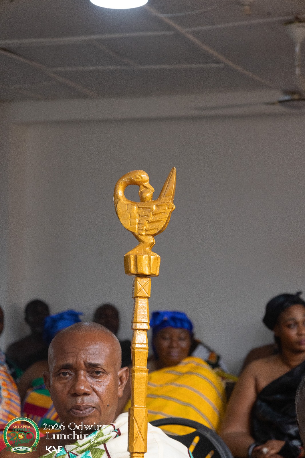 A gold bird finial with its head turned back over its wing